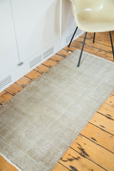 Hand-knotted distressed Oushak rug displaying textured wear with silver and grey tones.