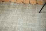 Distressed texture of a vintage Oushak rug in silver, grey, platinum, and white.