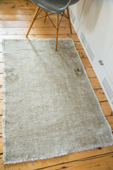 Distressed edge and fringe of a vintage Oushak rug, showing aged silver and platinum patina.