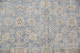 Distressed vintage Oushak rug pile featuring slate blue grey and beige floral palmettes.