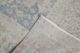 Distressed Oushak hand-knotted rug, showing worn slate blue pattern and tight reverse foundation.