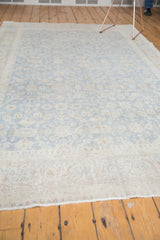 Distressed Oushak carpet with faded slate blue-grey and neutral floral palmettes, implied lattice.