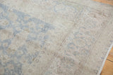 Distressed Oushak carpet pile with muted slate blue and beige floral palmettes.