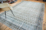 Distressed vintage Persian Khorassan carpet with allover paisley design in faded pastels.