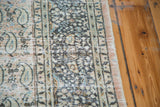 Faded peach, blue, and tan distressed paisley motifs on a Khorassan carpet.