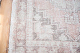 Distressed texture, faded blush rose, and charcoal in a geometric tribal pattern.