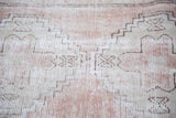 Distressed Oushak runner with faded blush rose and beige geometric tribal stepped patterns.