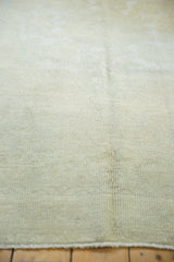 Textured pile of a distressed Oushak rug in light ivory and subtle silver.