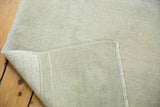 Distressed light ivory pile and tightly woven foundation of the vintage Oushak rug.