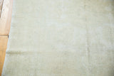 Hand-knotted distressed texture of a light ivory vintage Oushak rug.