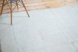 Distressed Oushak rug detail showing light bronze abrashes and soft aqua blue accents.