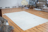 Distressed Oushak rug with subtle tone-on-tone pattern, showing aqua and bronze abrashes.