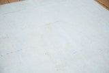 Distressed vintage Oushak rug texture with subtle light aqua and bronze abrashes.