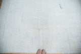 Hand-knotted backing of the distressed Oushak rug, revealing tight weave and pale blue details.