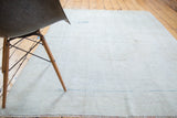 Distressed Oushak rug texture, subtle light bronze abrashes, aqua blue stitching.