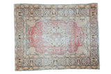 Distressed Oushak rug with star medallion on faded red field, gold, ivory, charcoal borders.