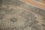 Distressed Turkish Oushak carpet with intricate geometric design and time-softened hues.