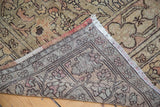 Detailed view of hand-knotted Oushak rug back, revealing distressed pile and fringe.