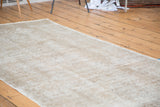 Distressed Oushak runner featuring faded beige and airy light tone pile.