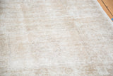 Distressed Oushak runner's textured pile in faded apricot, beige, and platinum tones.