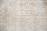 Vintage Oushak runner's distressed texture with faded beige, white, and platinum tones.