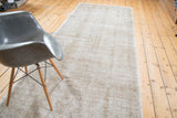 Subtle faded texture of distressed Oushak runner with light beige and platinum tones.