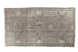 Distressed Oushak rug with faded neutral charcoal, silver, platinum geometric patterns.