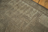 Faded geometric patterns and soft, distressed pile texture of the vintage Oushak rug.