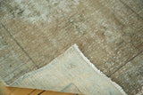 Distressed Oushak rug texture showing pile recession and woven foundation.