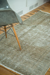 Textured detail of distressed Oushak rug, featuring soft, worn pile and visible foundation.