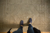 Pale grey distressed Oushak rug with subtle tone-on-tone medallion and texture.