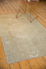 Distressed hand-knotted Oushak rug showcasing its pale grey field and faded medallion.