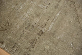Textured distressed Oushak rug with muted pale grey tones and subtle worn patterns.