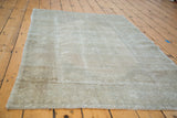 Soft, distressed texture of beige and silver tones with subtle rectilinear weaving.
