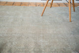 Distressed Turkish Oushak rug pile, muted beige and silver analogous tones, faded rectilinear pattern.