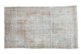 Distressed vintage Turkish Oushak rug with a faded dusty rose field and subtle medallion, 4'4