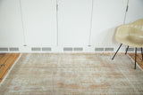 Soft textural distressed Oushak rug in muted dusty rose and light tones.