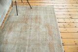 Distressed Oushak rug field with faded dusty rose and silver platinum tones.