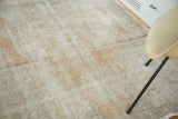Soft, distressed pile of vintage Oushak rug with faded dusty rose field.