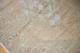 Distressed Oushak runner pile, showing faded rectilinear patterns and muted earth tones.