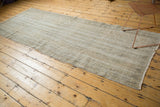 Distressed Turkish Oushak runner, finely shorn, showing subtle weaving lines and neutral tones.
