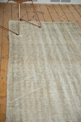 Distressed Oushak rug texture, finely shorn, revealing subtle diagonal weaver lines from hand-knotting.