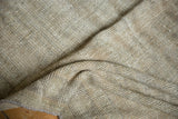 Distressed Oushak rug's shorn low pile and subtle diagonal weave in natural neutral tones.