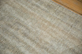 Distressed Oushak rug texture revealing beige and ivory knot heads at foundation.