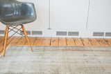Distressed vintage Turkish Oushak rug with faded apricot, light white, and pewter tones.
