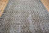 Distressed texture revealing subtle grey, charcoal, and faded green allover Oushak pattern.