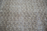 Textured distressed Oushak carpet with faded allover motifs in grey and charcoal.