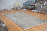Distressed Oushak carpet, vintage, showing subtle grey, charcoal, and faded green allover pattern.