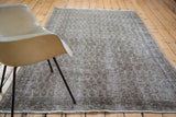 Distressed hand knotted Oushak texture in faded grey, charcoal, and subtle green.