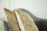 Hand-knotted texture of vintage Turkish Oushak rug pillow, with subtle pink geometric motifs.